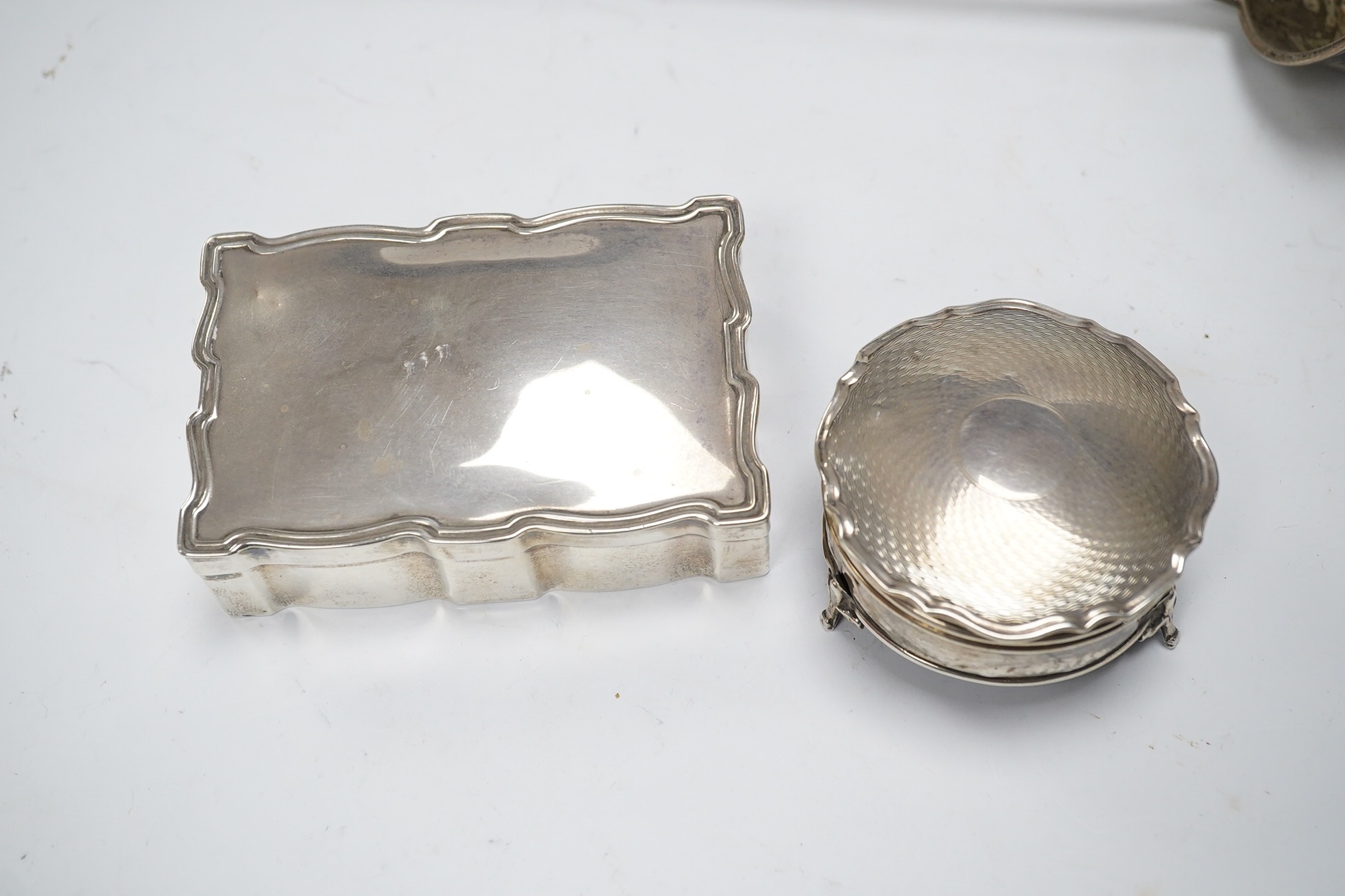 Two George V silver mounted trinket boxes, including rectangular by A & J Zimmerman & Co, 10.7cm, together with a white metal soup ladle. Condition - poor to fair